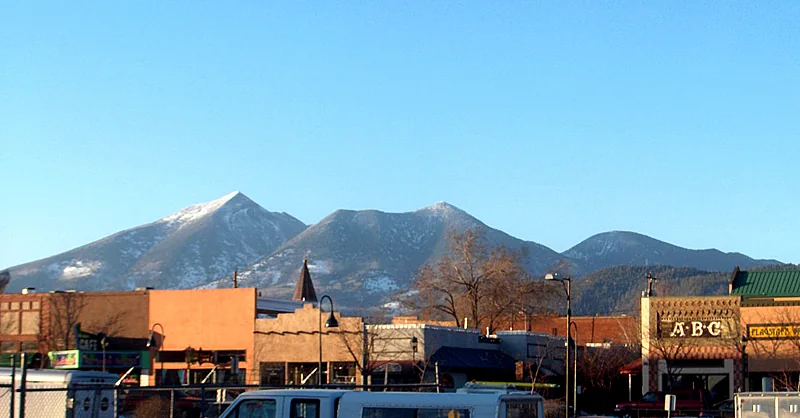 Route 66 in downtown Flagstaff, with the San Francisco Peaks in the distance