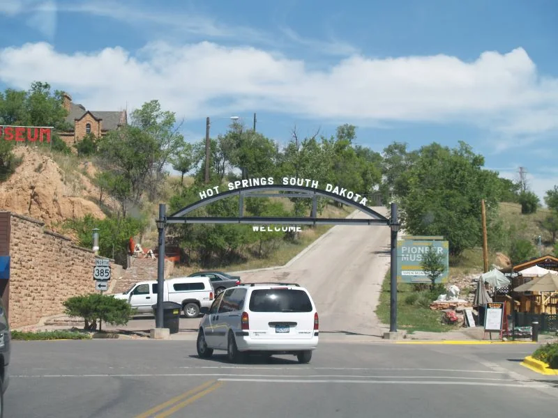 The welcome sign and landscape at Hot Springs, South Dakota