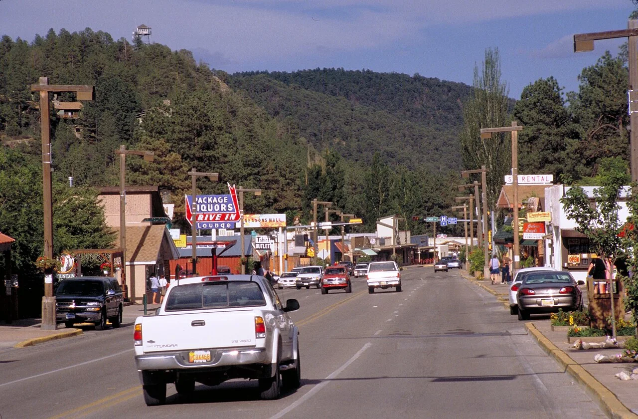 Downtown Ruidoso and its forested surroundings in a historical photograph
