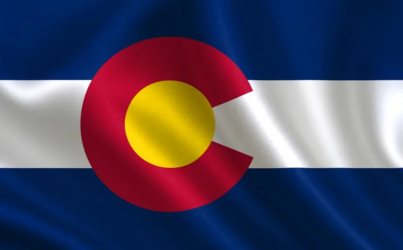 Colorado state flag with a red C and gold center over blue and white stripes