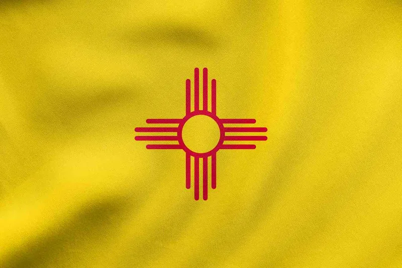 New Mexico state flag with a red Zia sun symbol on a yellow field