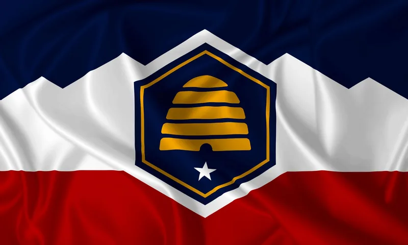 Utah state flag with a gold beehive, white mountain band, and blue and red fields