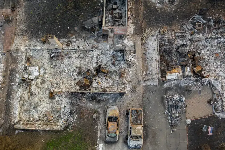 Aerial view of a fire-damaged building site and surrounding debris