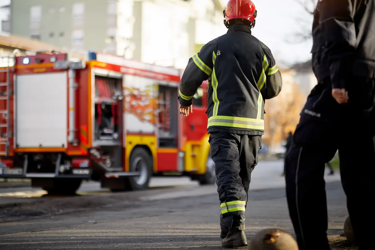 Firefighter walking toward a parked fire engine