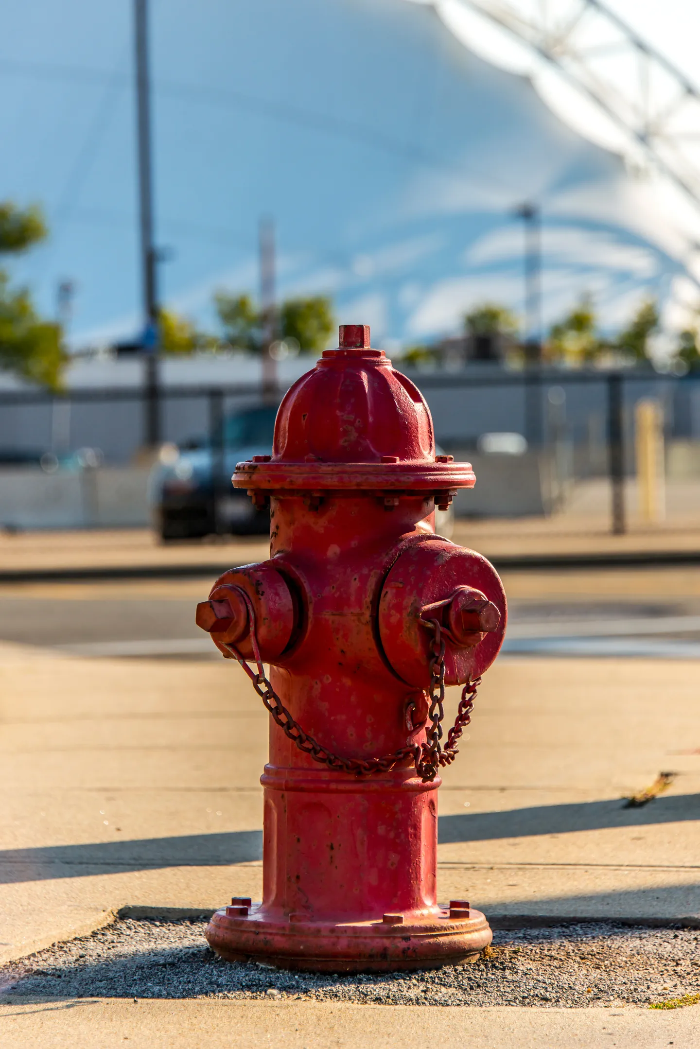 Red fire hydrant beside an urban street